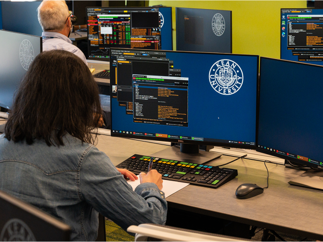 Students work on Bloomberg terminals in Kean's College of Business and Public Management