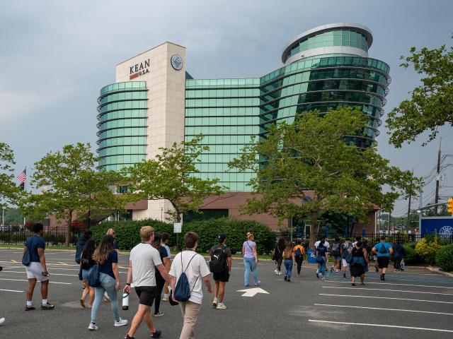 Students walk across the Kean campus during orientation. GLAAB is visible in background.