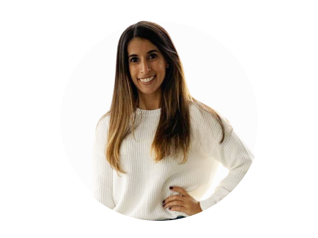 A young woman with long brown hair wearing a white sweater.