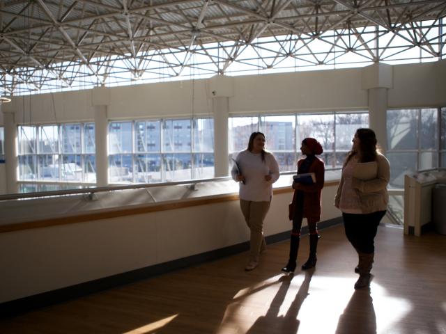 Atmospheric photo of students walking in a modern classroom building