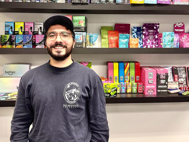 Mike Kapotis stands in front of a display of products his company designed