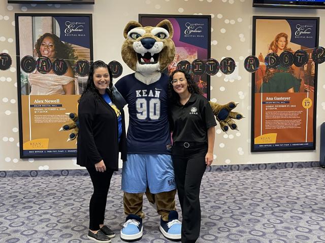 The Kean Cougar joins educators in the lobby of Enlow Auditorium