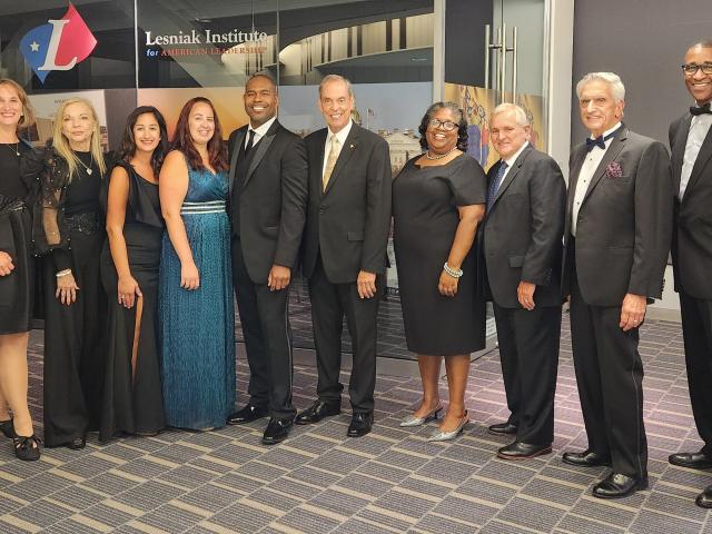 Group photo of alumni association members in formal attire