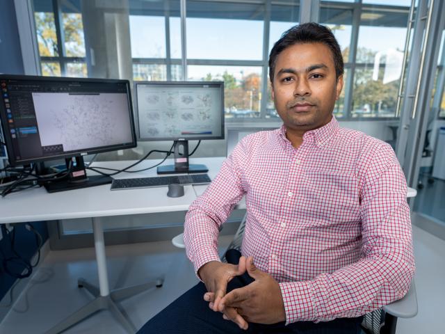 Supratik Kar, Ph.D. is pictured at the computer in his office at Hennings