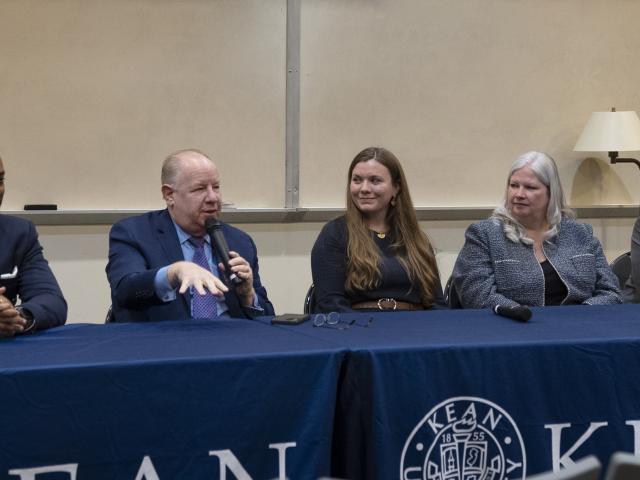 Panelists in the Public Affairs career forum speak to students at a dais