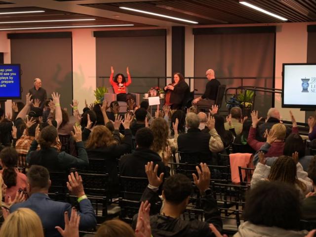 Lauren Ridloff gives her lecture, the audience use their hands to show applause