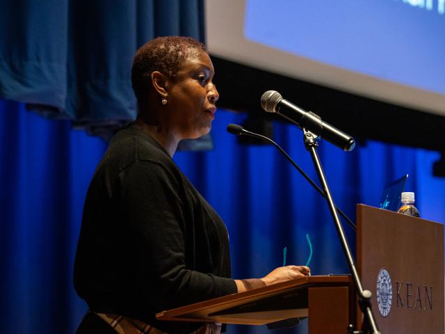 Barbara George Johnson speaks at a podium at Kean