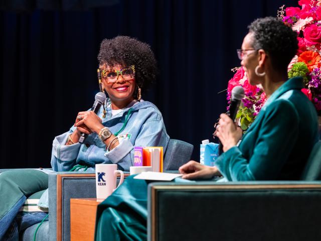 Tabitha Brown faces camera, talking with Darlene Repollet