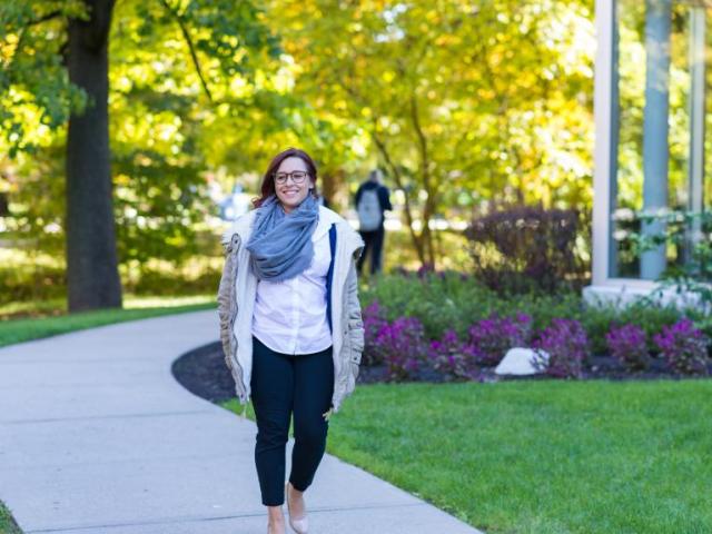 Graduate student walks along Cougar Walk