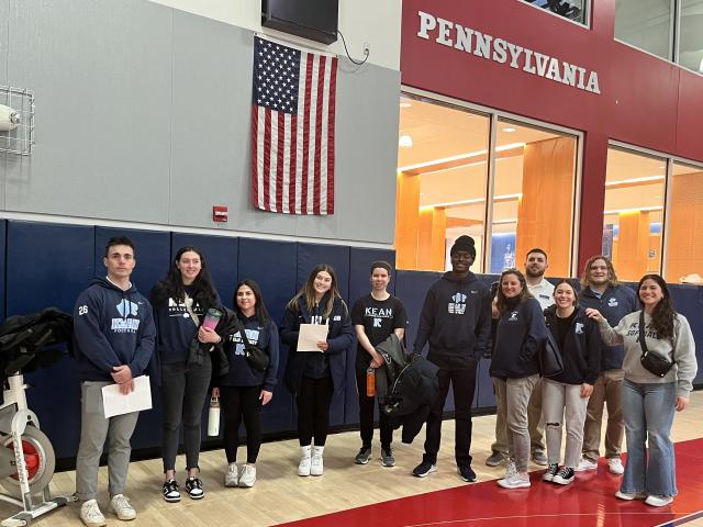 Students from Kean's KUBS program stand on the basketball court at U Penn