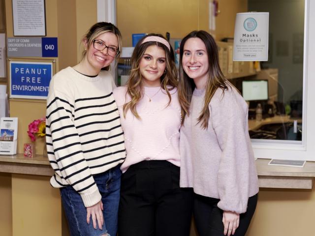 Three young women, Kean grad students in speech language pathology, at the communication disorders clinic