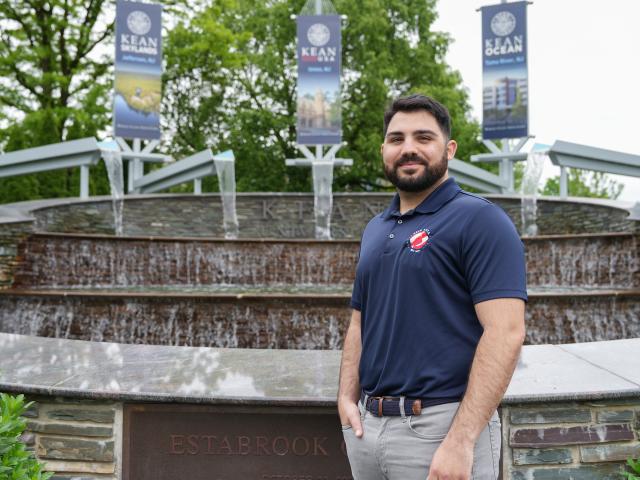 Frank Capone is photographed in front of the fountain at Kean.