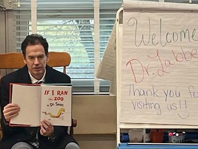 Sayreville Superintendent Richard Labbe reads to children. He is a Kean alum.