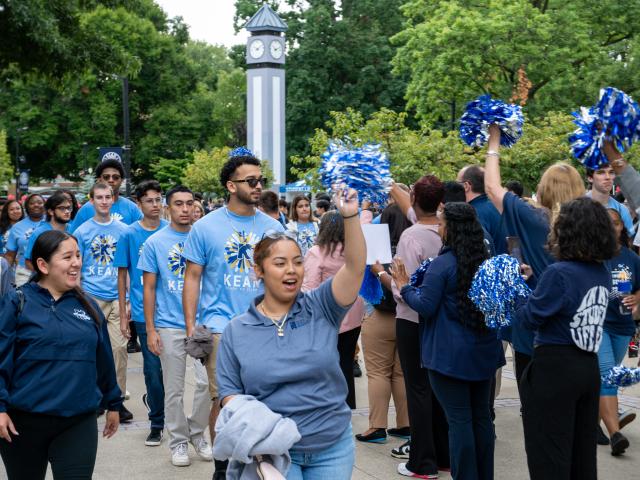 Students march and Kean faculty and staff cheer them on at convocation