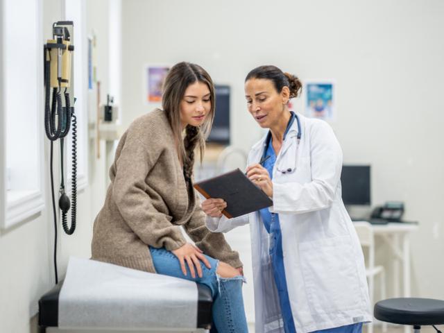 Physician consults with student patient