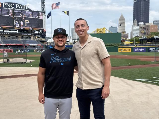 Tyler Smarslok and Stephen Strom post together on the field of the Miami Marlins baseball team.