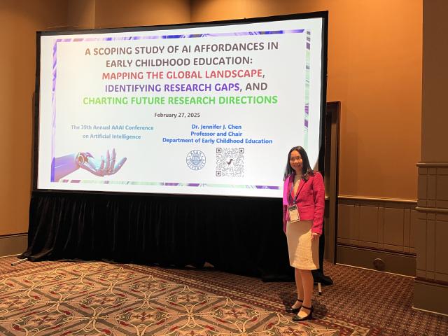 Jennifer Chen in front of a presentation on AI