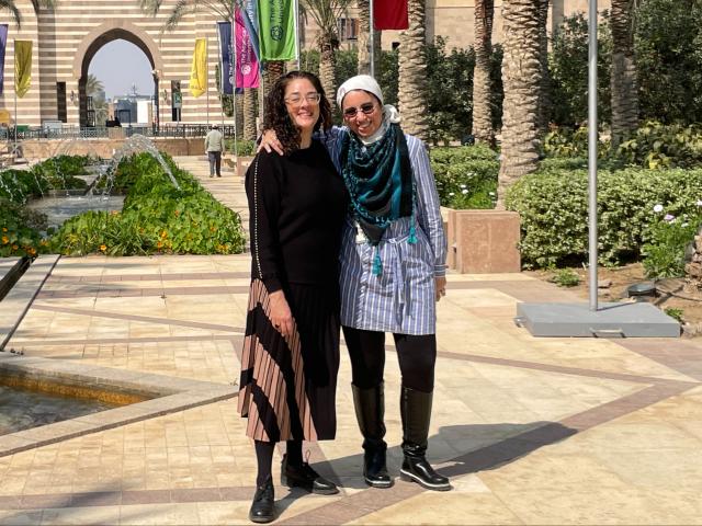 Kean professor in a courtyard with a colleague