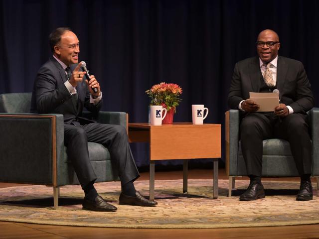 Mark Tatum speaks on stage at Kean alongside Kelly Williams, vice president of athletics and recreation.