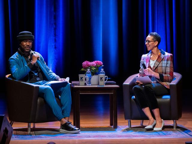 Nate Burleson speaking on stage with First Lady Darlene Repollet
