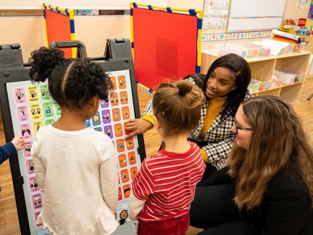 Young students learning from a teacher 