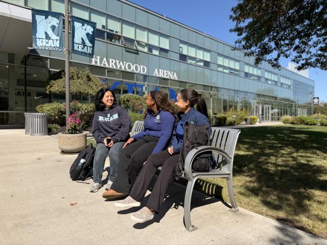 Students sitting on bench and talking