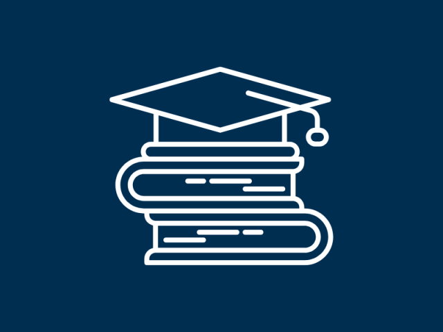 A graduation cap perched on top of a stack of books 