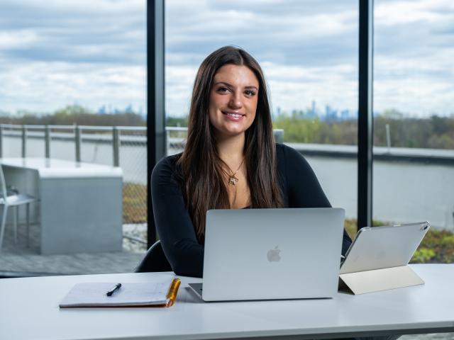 A Kean Global student studies in an office building with a stunning view
