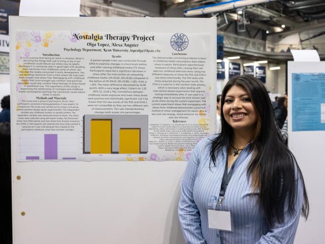 Student in front of a poster presenting