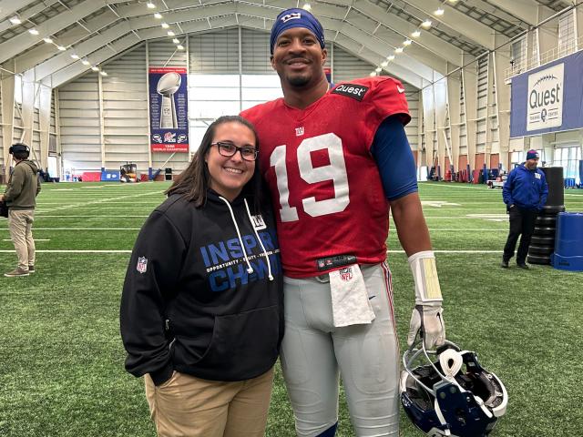 Woman and football player on a football field 