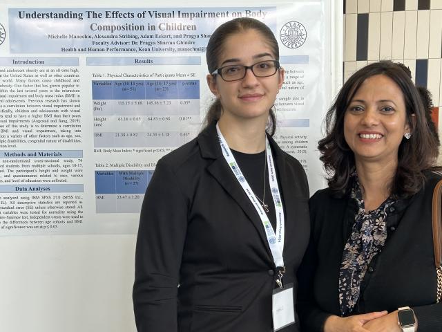 Two women in front of a poster
