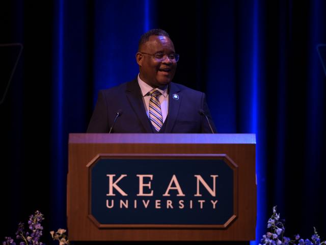 President Repollet speaks at a podium