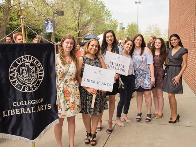 students lining up with their school banner for honors convocation