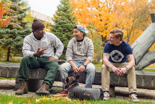 Three Kean students converse outside