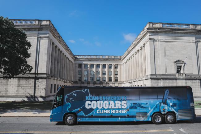 Kean University Bus with Cougars Climb Higher wrap, in front of Statehouse