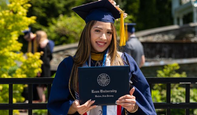 Kean graduate poses with her diploma
