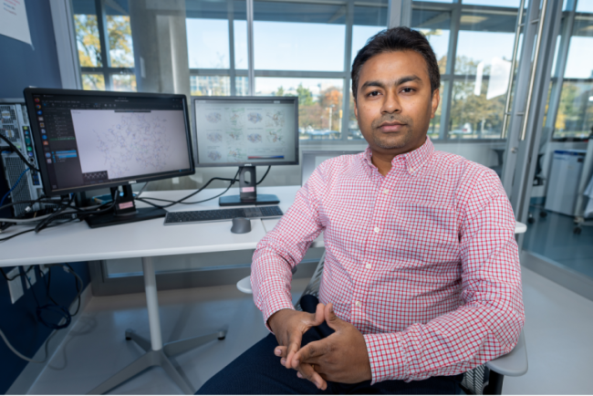 Supratik Kar seated at the desk in his office