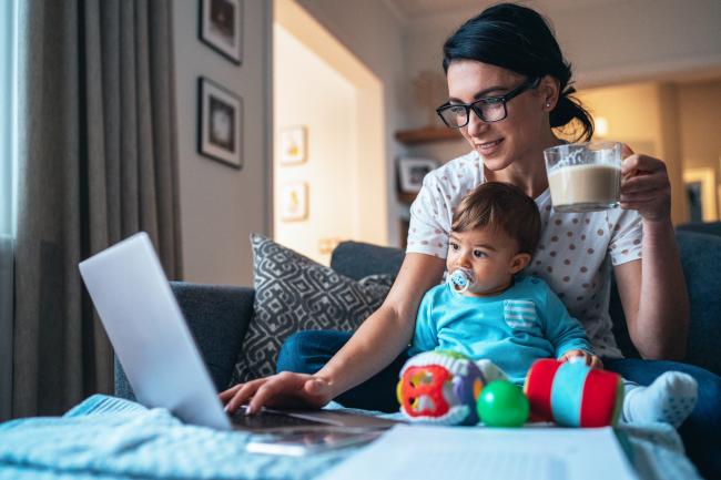 An adult learner studies for her master's program while caring for an infant