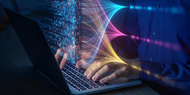 A colorful abstract graphic depicting a programmer coding