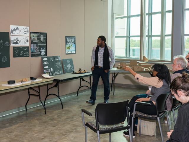 A Kean architecture student makes a presentation before professors and students.