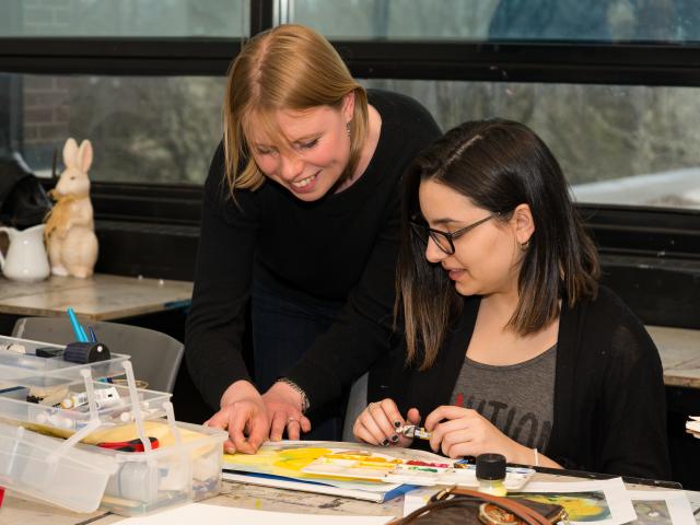Kean professor Anna Shukeylo instructs a Fine Arts student in drawing.