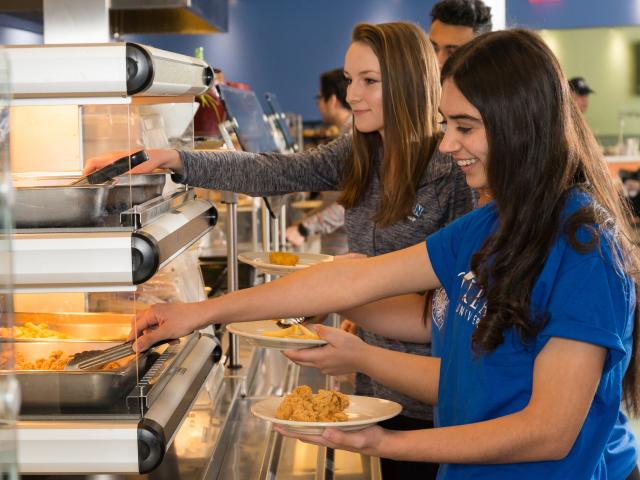 Students serve themselves in the cafeteria line