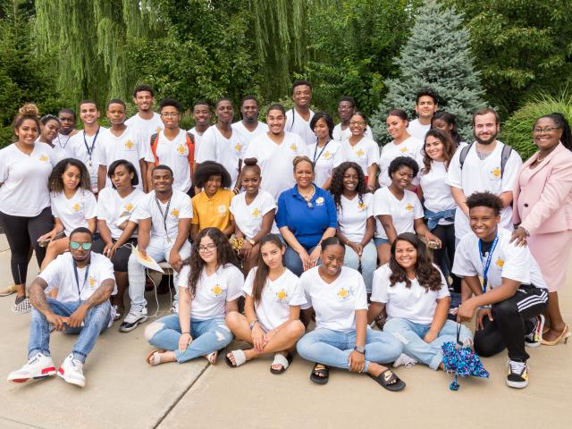 Outdoor group photo of EEO students and the program's director