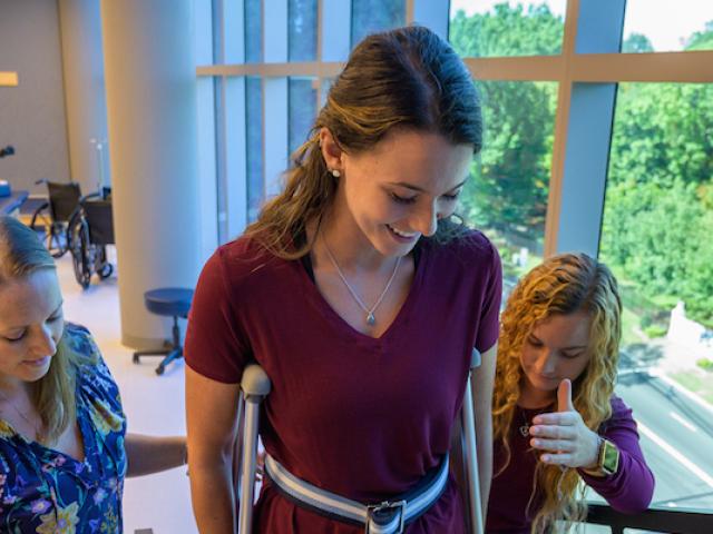 DPT students assist a patient