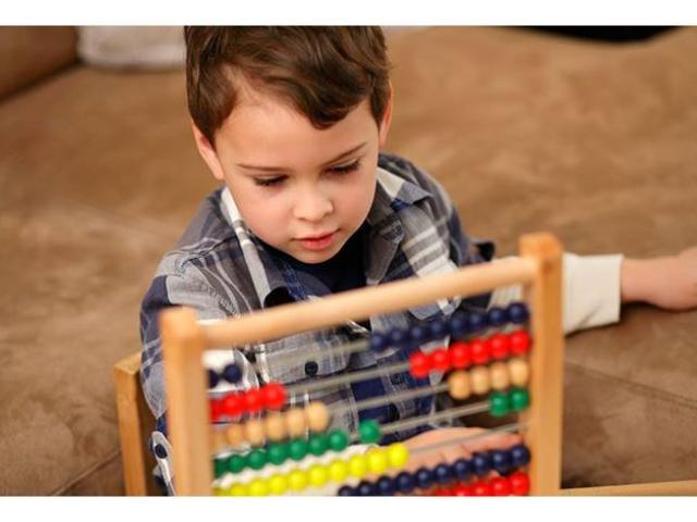 Autistic child uses abacus for treatment