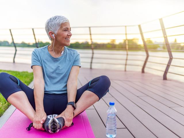 Woman stretches outside