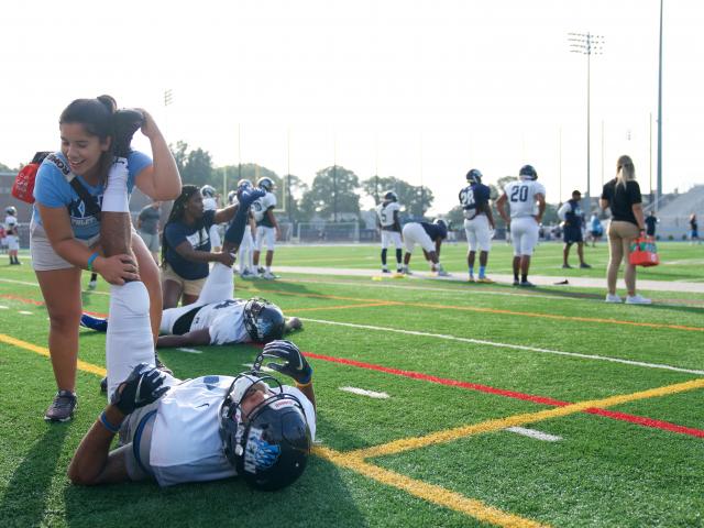 Athletic trainers treat athletes on the football field