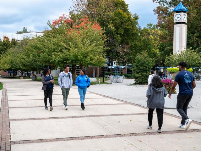 Kean students walk past the clock tower