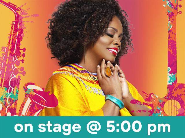 Dianne Reeves on stage at 5 pm smiling and with her hands together