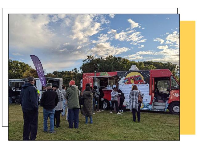 A group of people in line, in front of a food truck titled Rolling Yatai